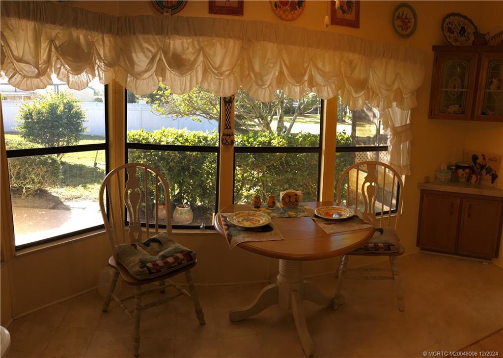 16222 Southwest Five Wood Way Indiantown, FL 34956 - Photo 6 of 13 a room with furniture and large windows