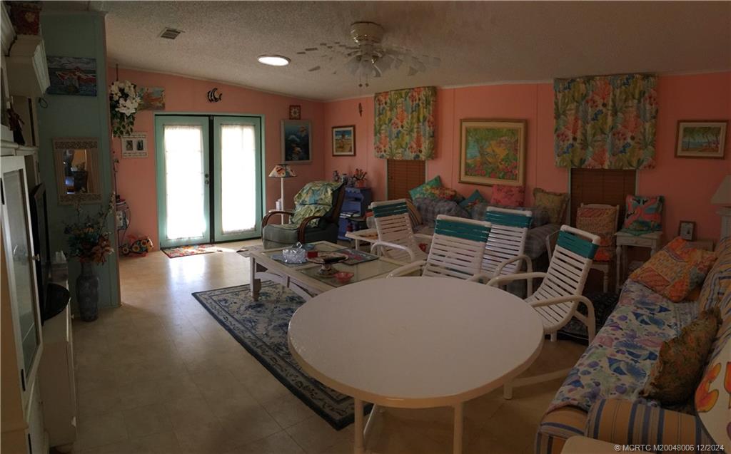 16222 Southwest Five Wood Way Indiantown, FL 34956 - Photo 8 of 13 a living room with furniture and a large window