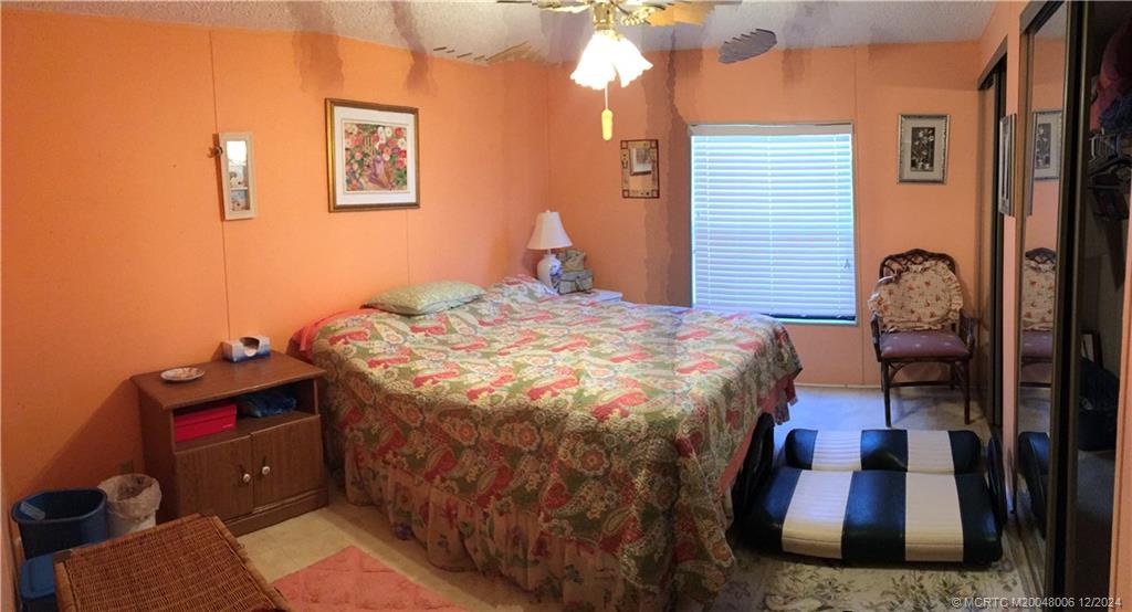 16222 Southwest Five Wood Way Indiantown, FL 34956 - Photo 10 of 13 a bed sitting in a room next to a window