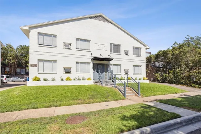 a view of a house with a yard patio and fire pit