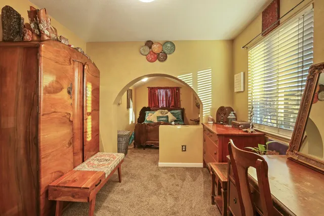 a view of a workspace with furniture and a window