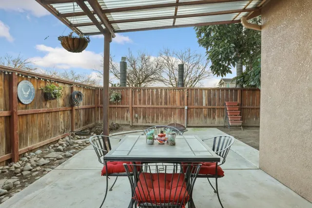 a view of a chairs and table in the patio