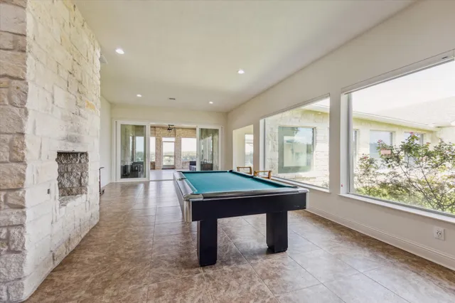 a living room with furniture and a large window with garden view