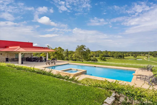 a big yard with trees in front of it