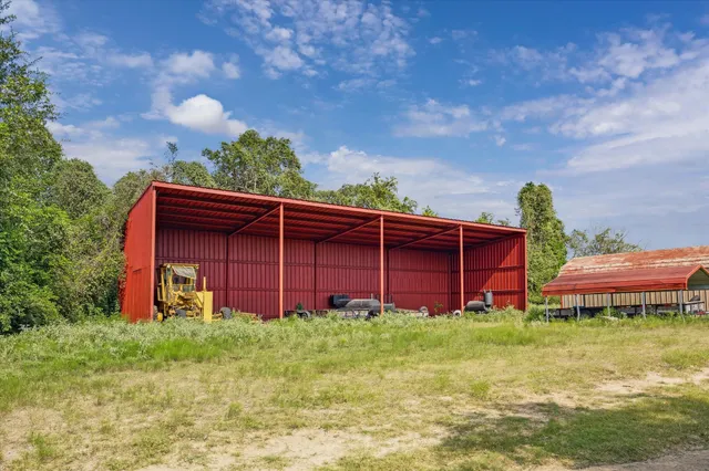 a view of a house with a big yard and a large tree