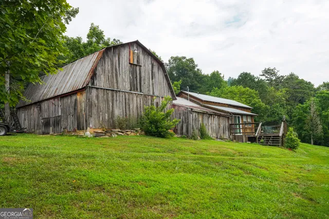 a view of a lush green hillside and houses