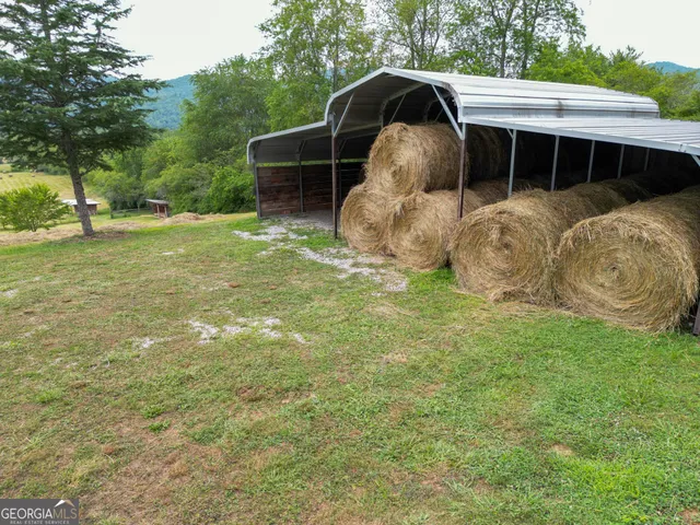 a view of a lush green hillside and houses