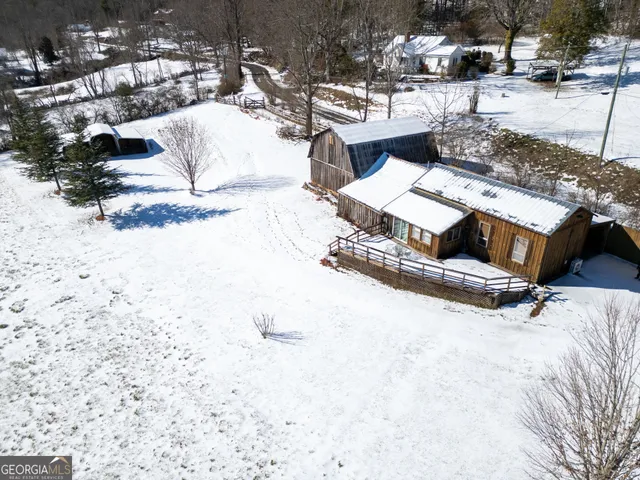a view of a house with a snow in the yard