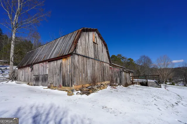 a view of a lush green hillside and houses