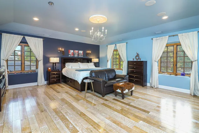 a bedroom with furniture and a large window