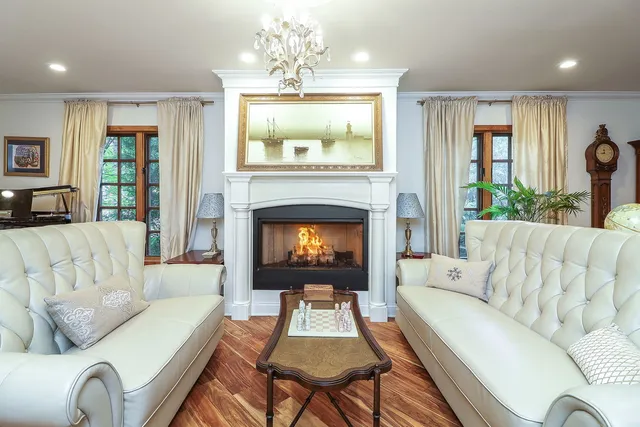 a living room with furniture and a fireplace