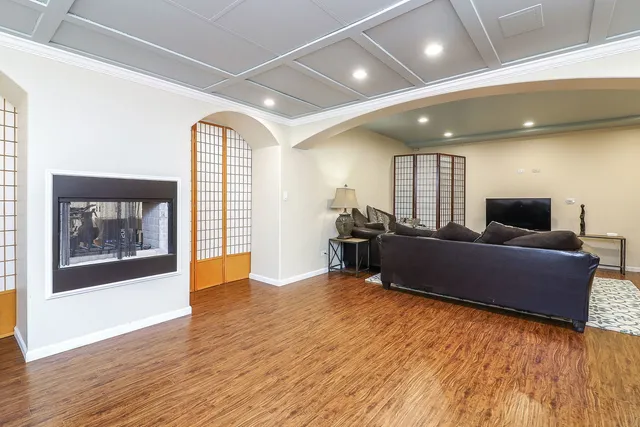 a room with gym equipment and wooden floor