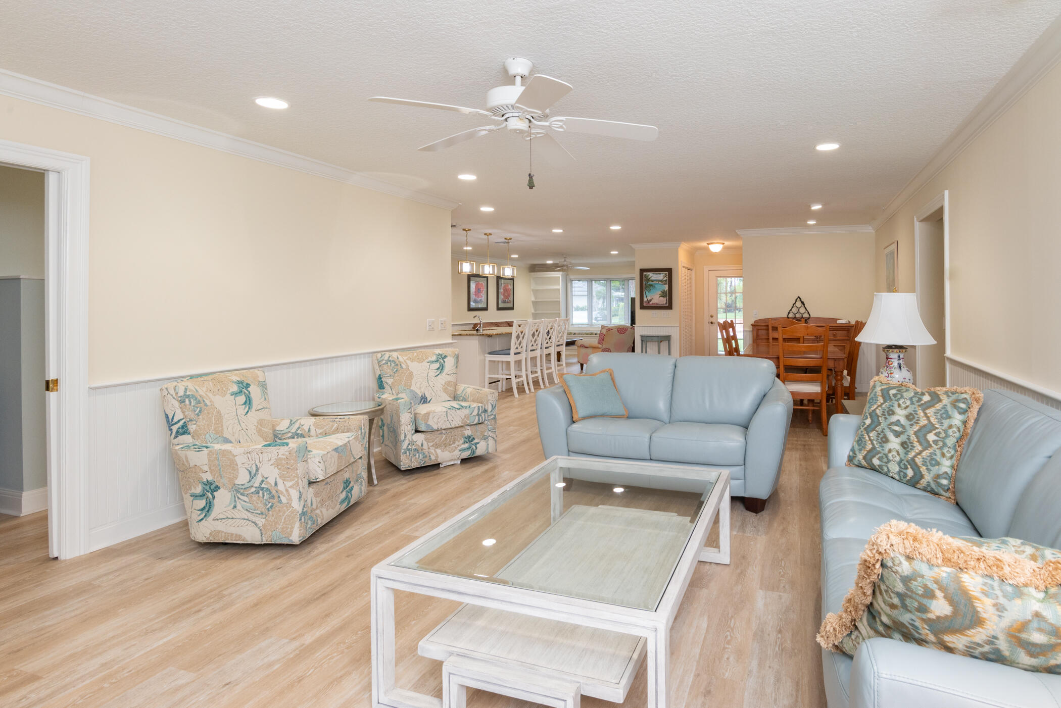 2918 Southeast Fairway West, Unit 13 Stuart, FL 34997 - Photo 17 of 35 a living room with furniture and a chandelier