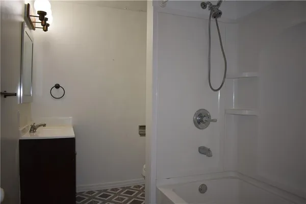 a bathroom with a shower and a sink
