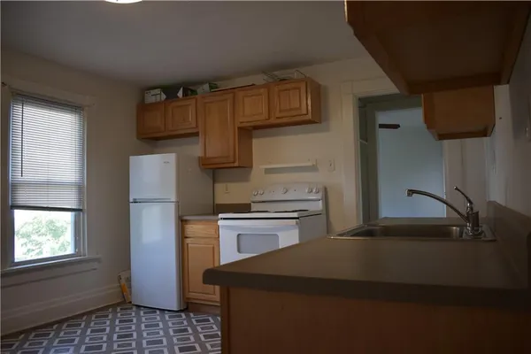 a kitchen with a sink appliances and cabinets