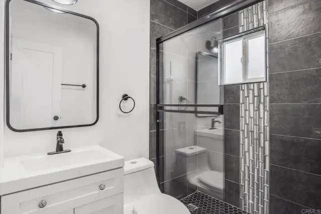 a bathroom with a toilet sink and shower
