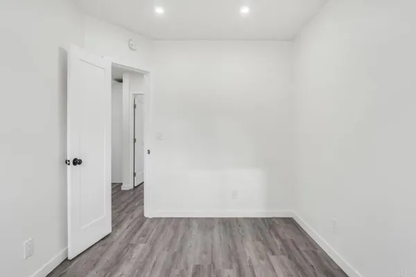 a view of a small space with wooden floor and a window