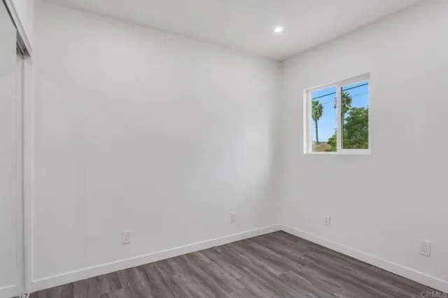 a view of room with wooden floor and fan