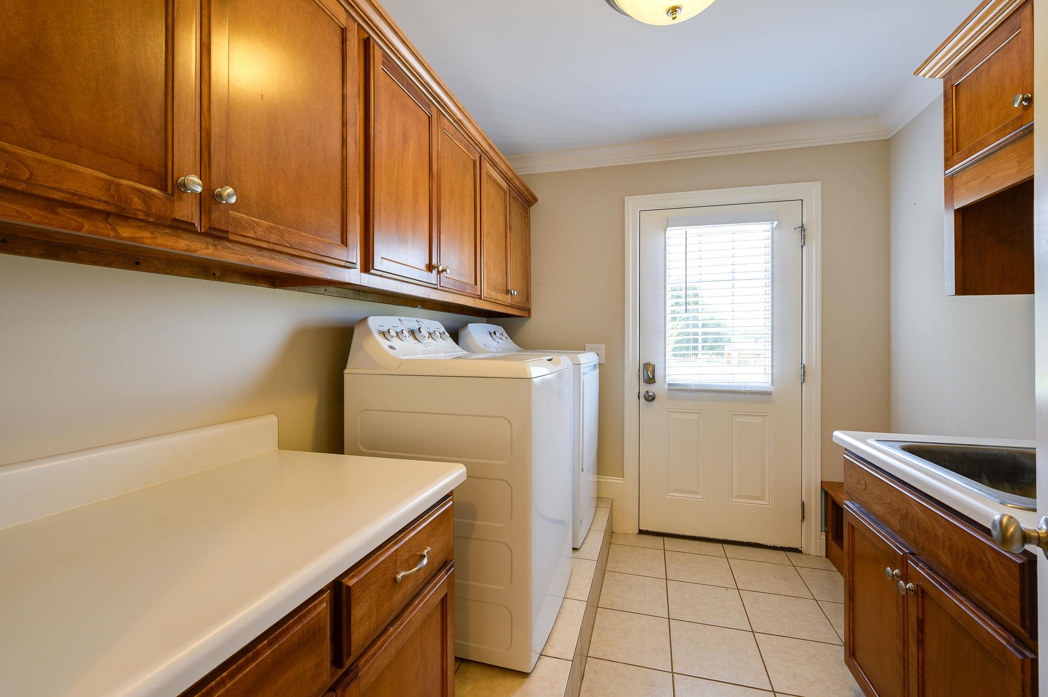 8460 East Gum Road Murfreesboro, TN 37127 - Photo 14 of 30 HUGE Laundry Room on first level! Complete with Cabinets & Sink! Washer/Dryer REMAIN!