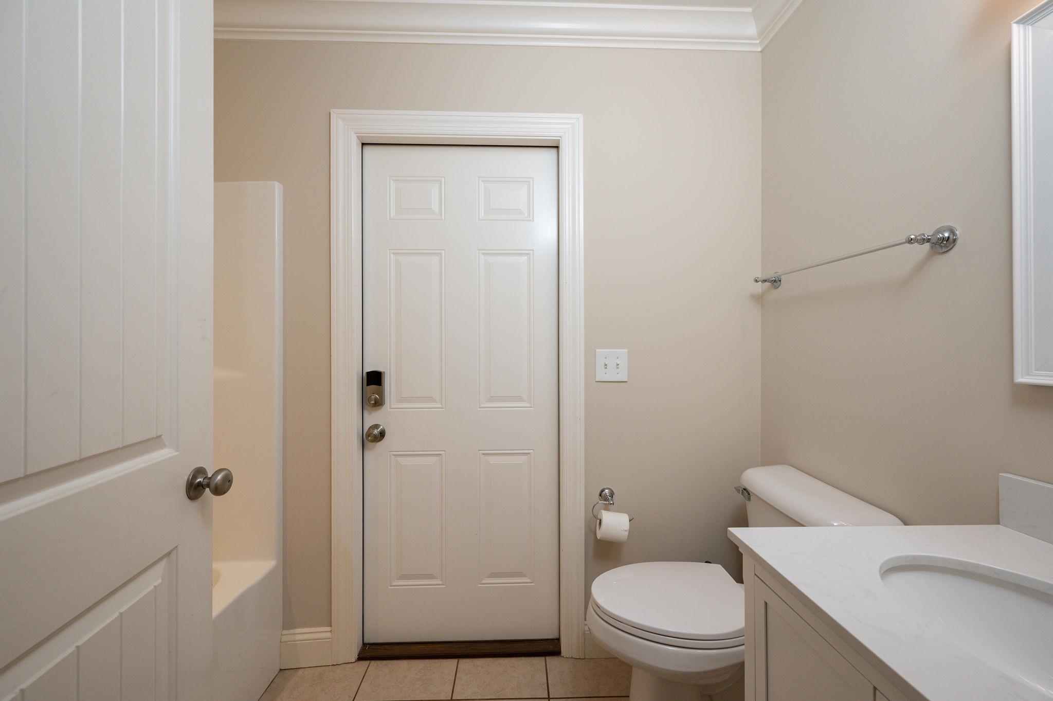 8460 East Gum Road Murfreesboro, TN 37127 - Photo 21 of 30 Full Guest Bath on first level complete with door to backyard (Perfect for those wanting access to a pool!)