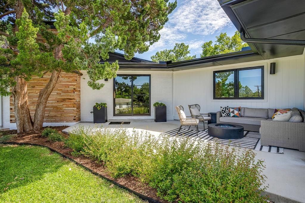6700 Fortune Road Fort Worth, TX 76116 - Photo 4 of 40 Expansive concrete patio area featuring white siding and black-trimmed windows