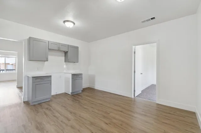 a living room with furniture and a kitchen view