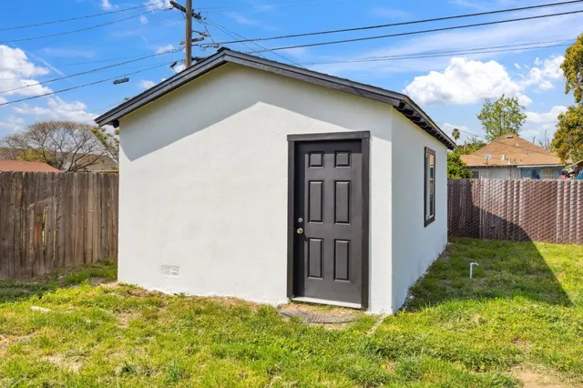 a view of backyard with swimming pool and outdoor seating
