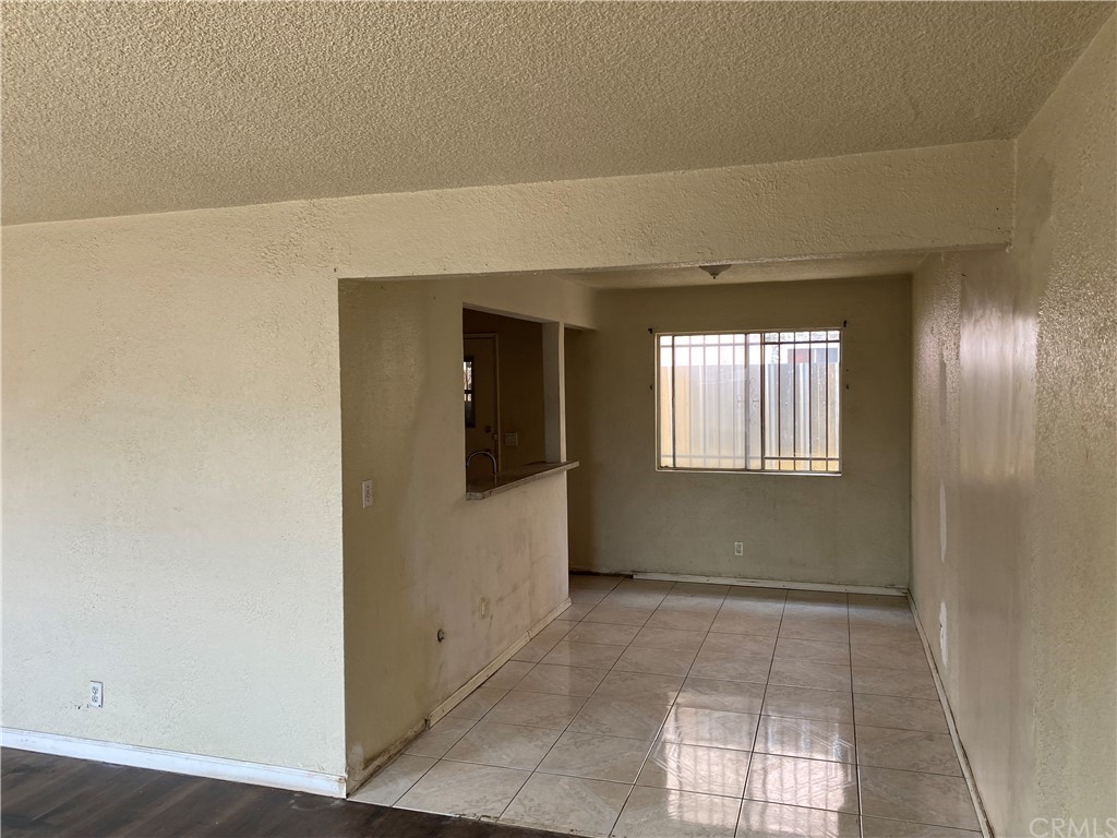 823 East 75th Street Los Angeles, CA 90001 - Photo 11 of 13 a view of an empty room with wooden floor and a window