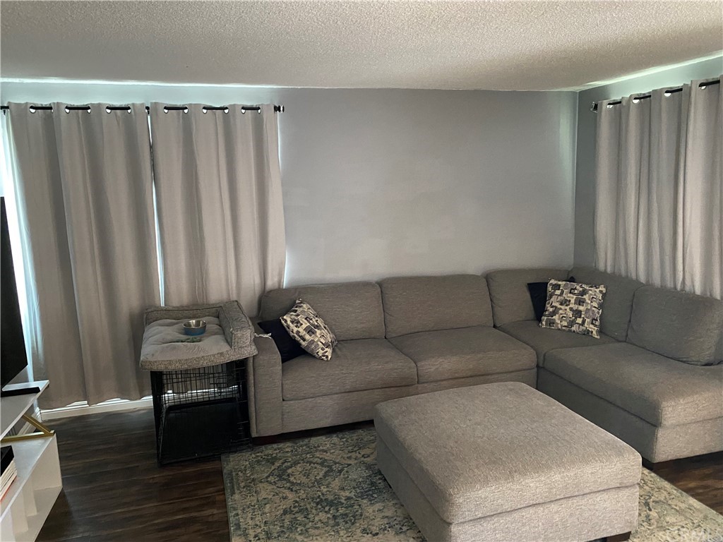 823 East 75th Street Los Angeles, CA 90001 - Photo 5 of 13 a living room with furniture and a couch