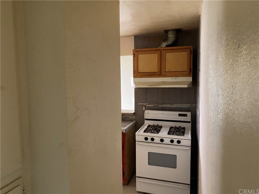 823 East 75th Street Los Angeles, CA 90001 - Photo 8 of 13 a kitchen with a stove and a microwave