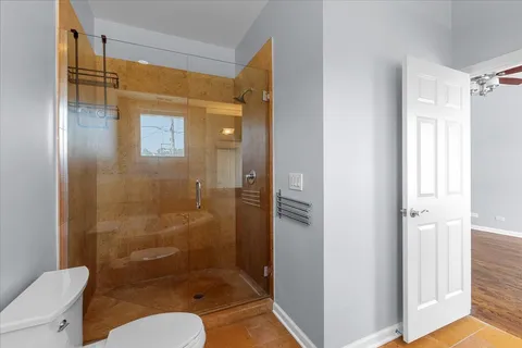 a bathroom with a shower a toilet and a sink