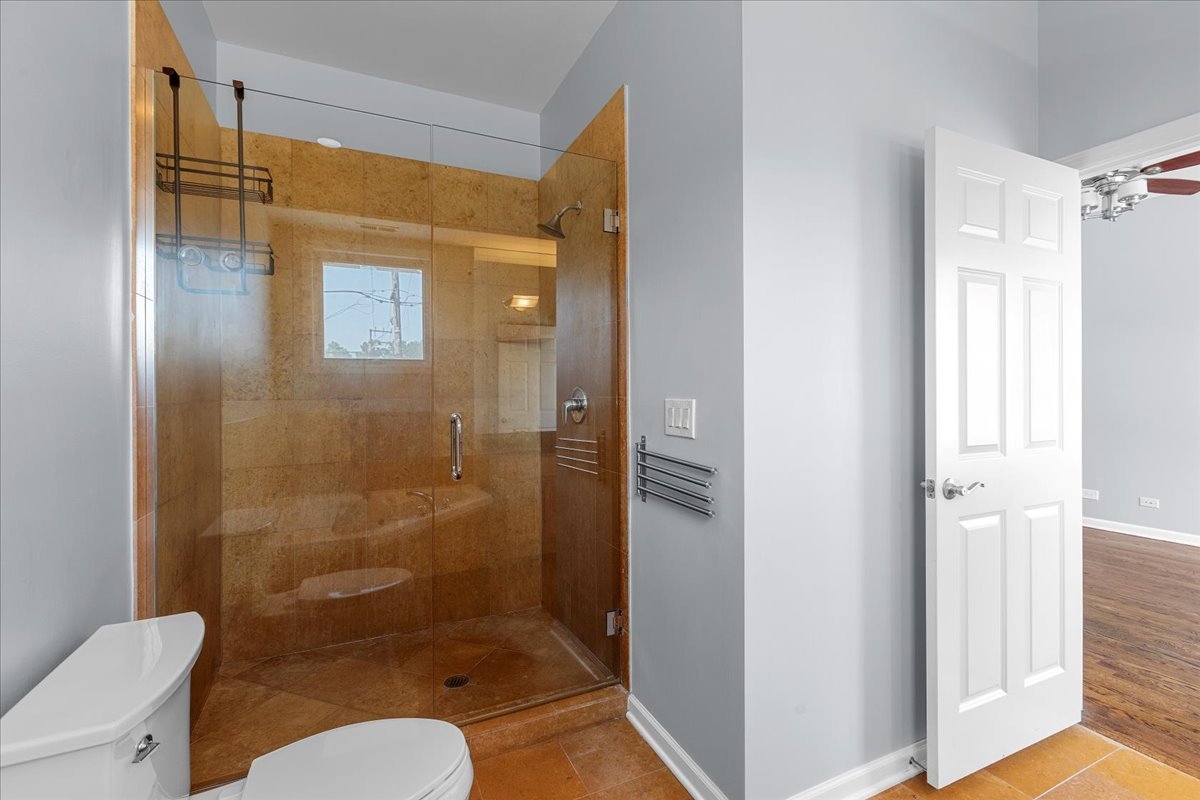 1610 West Grand Avenue, Unit 2C Chicago, IL 60622 - Photo 8 of 13 a bathroom with a shower a toilet and a sink