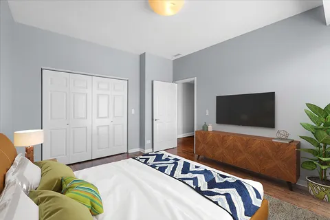 a bedroom with a bed and a flat screen tv
