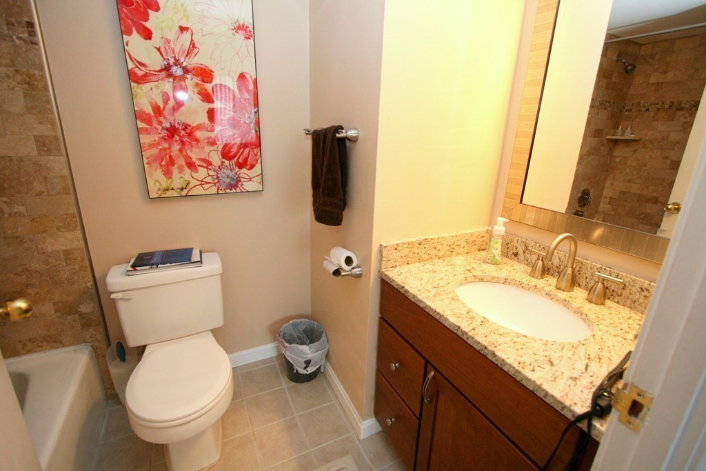 85 Brainerd Road, Unit 510 Boston, MA 02134 - Photo 9 of 25 a bathroom with a granite countertop toilet and a sink