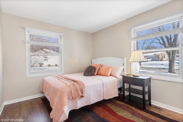 a bedroom with a bed and a painting on the wall