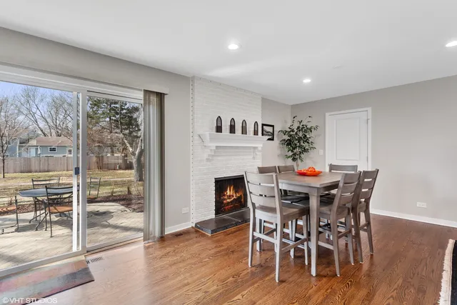a view of a dining room with furniture wooden floor and a floor to ceiling window