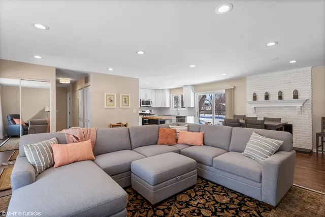 a living room with furniture and a view of kitchen
