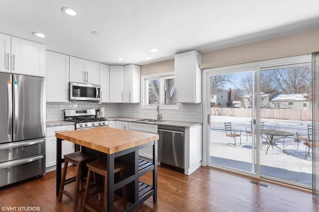 a kitchen with a stove a sink and a refrigerator