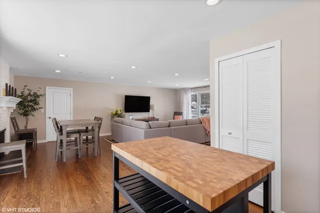 a living room with furniture a flat screen tv and a table