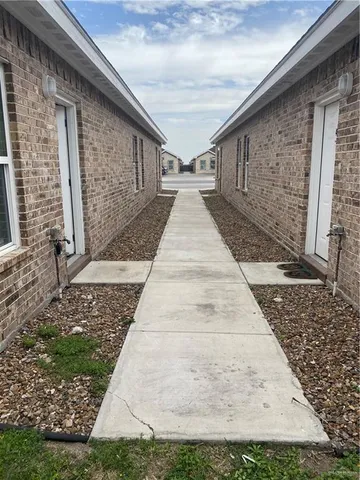 a view of a kitchen with wooden floor and a sink