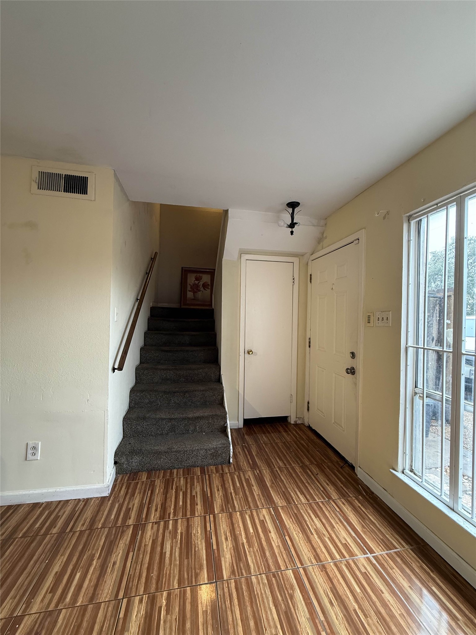 7047 Bissonnet Street, Unit 70 Houston, TX 77074 - Photo 11 of 23 a view of a hallway with wooden floor and staircase