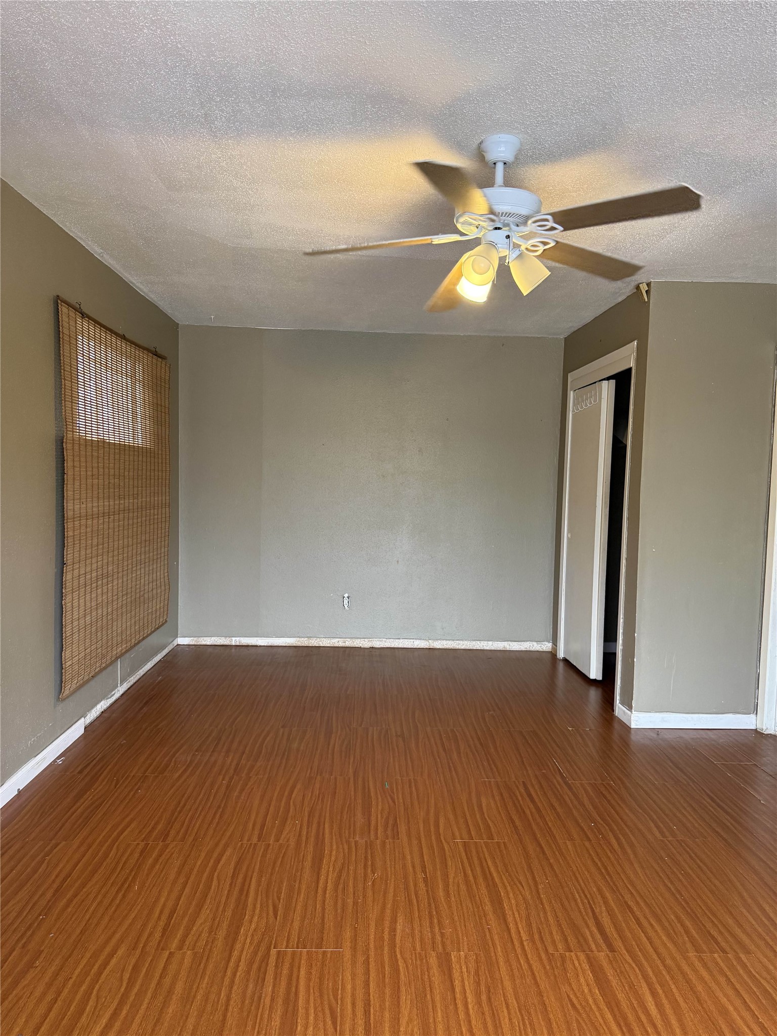 7047 Bissonnet Street, Unit 70 Houston, TX 77074 - Photo 12 of 23 a view of an empty room with wooden floor and a window