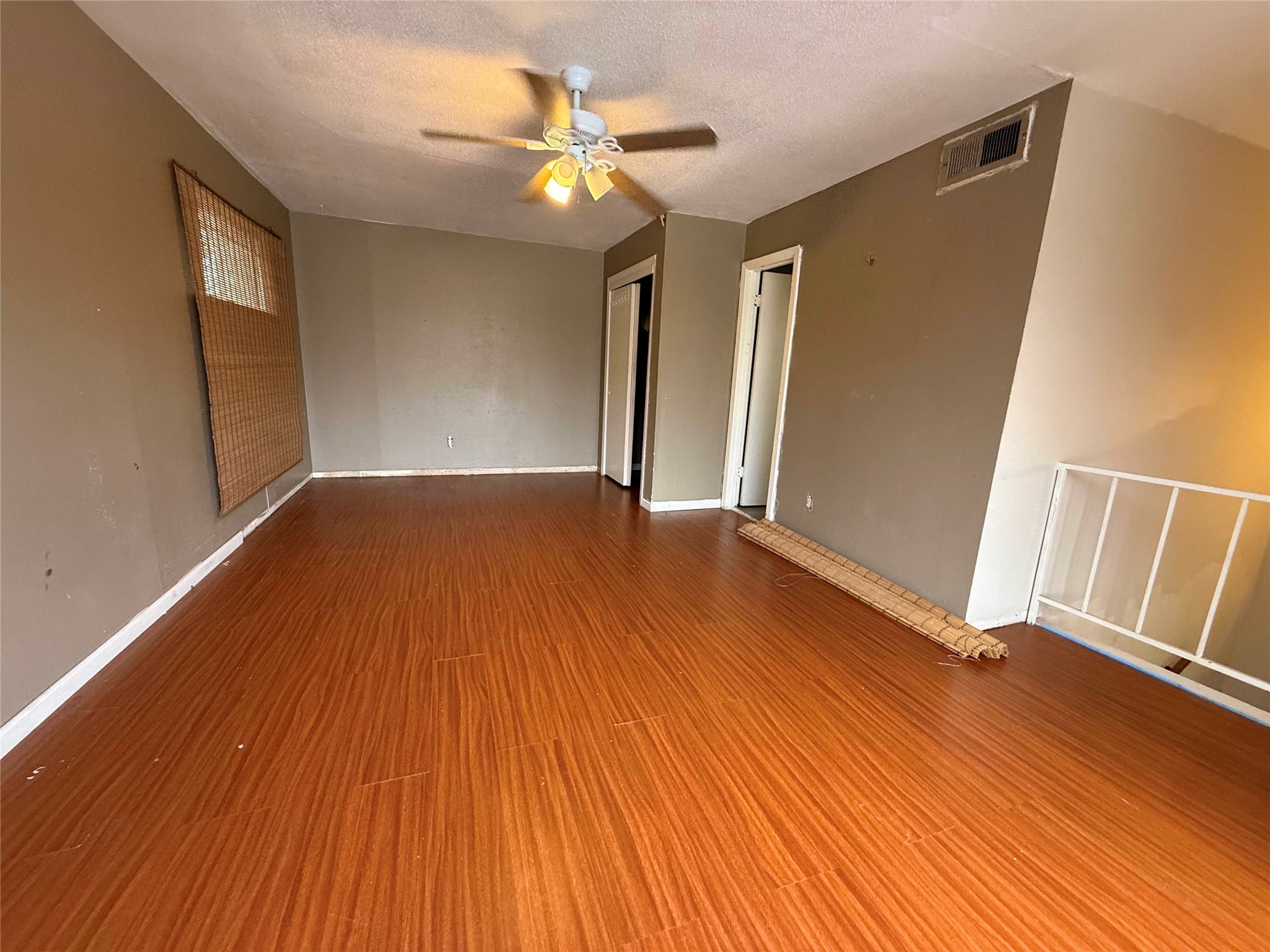 7047 Bissonnet Street, Unit 70 Houston, TX 77074 - Photo 13 of 23 a view of an empty room with wooden floor and a window