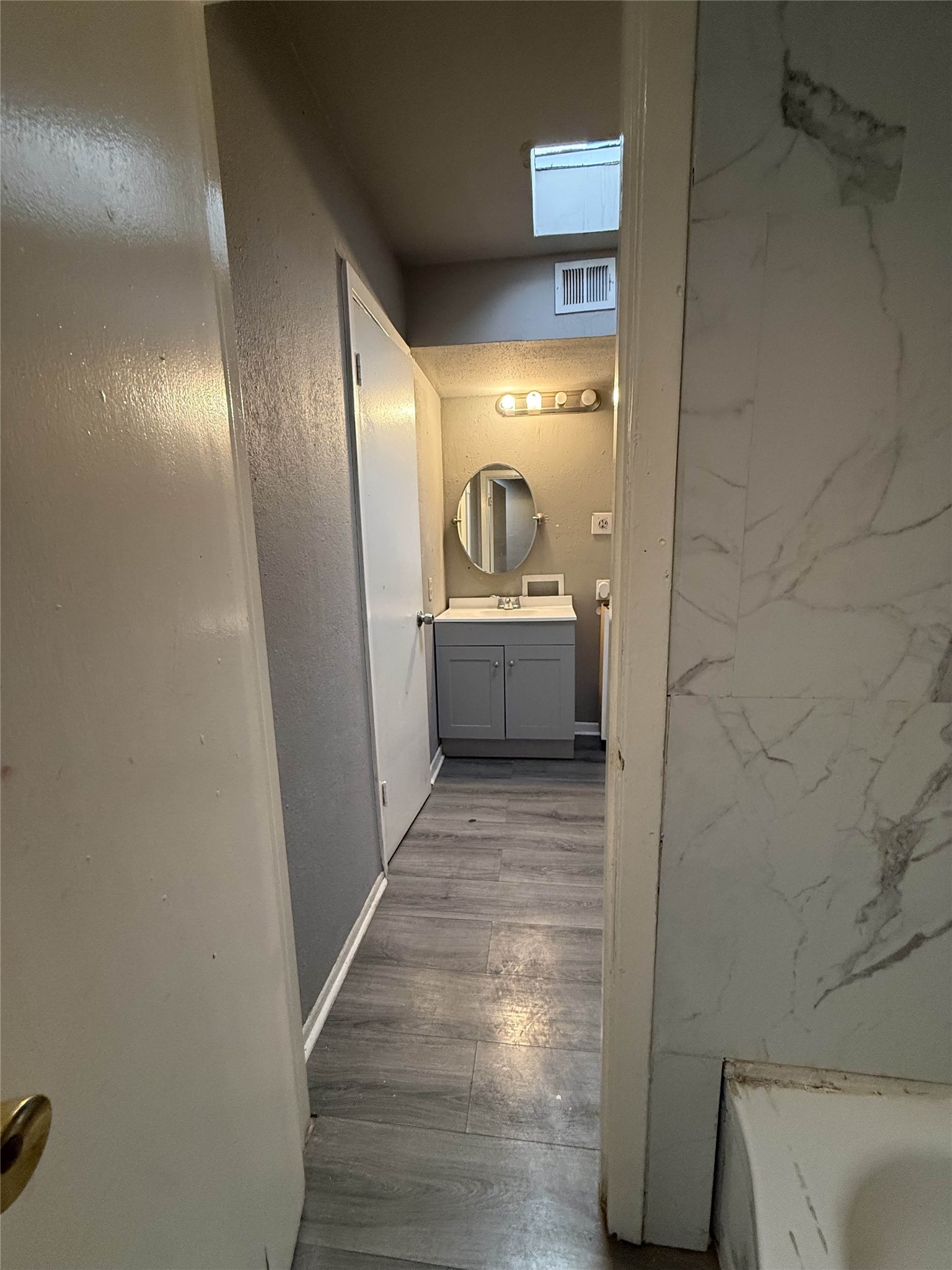 7047 Bissonnet Street, Unit 70 Houston, TX 77074 - Photo 15 of 23 a bathroom with a sink and a mirror