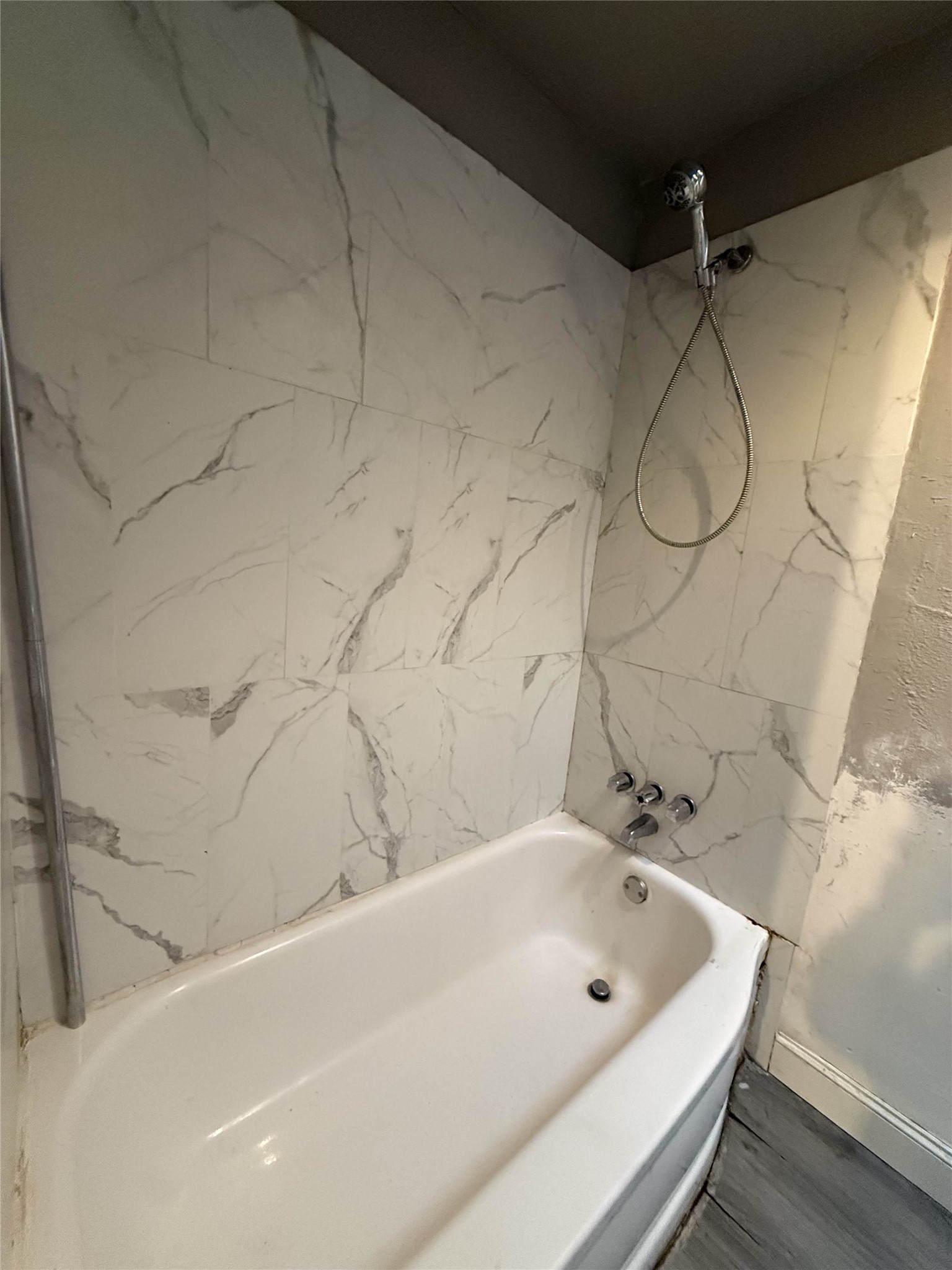 7047 Bissonnet Street, Unit 70 Houston, TX 77074 - Photo 17 of 23 a bathroom with a white bath tub and a shower