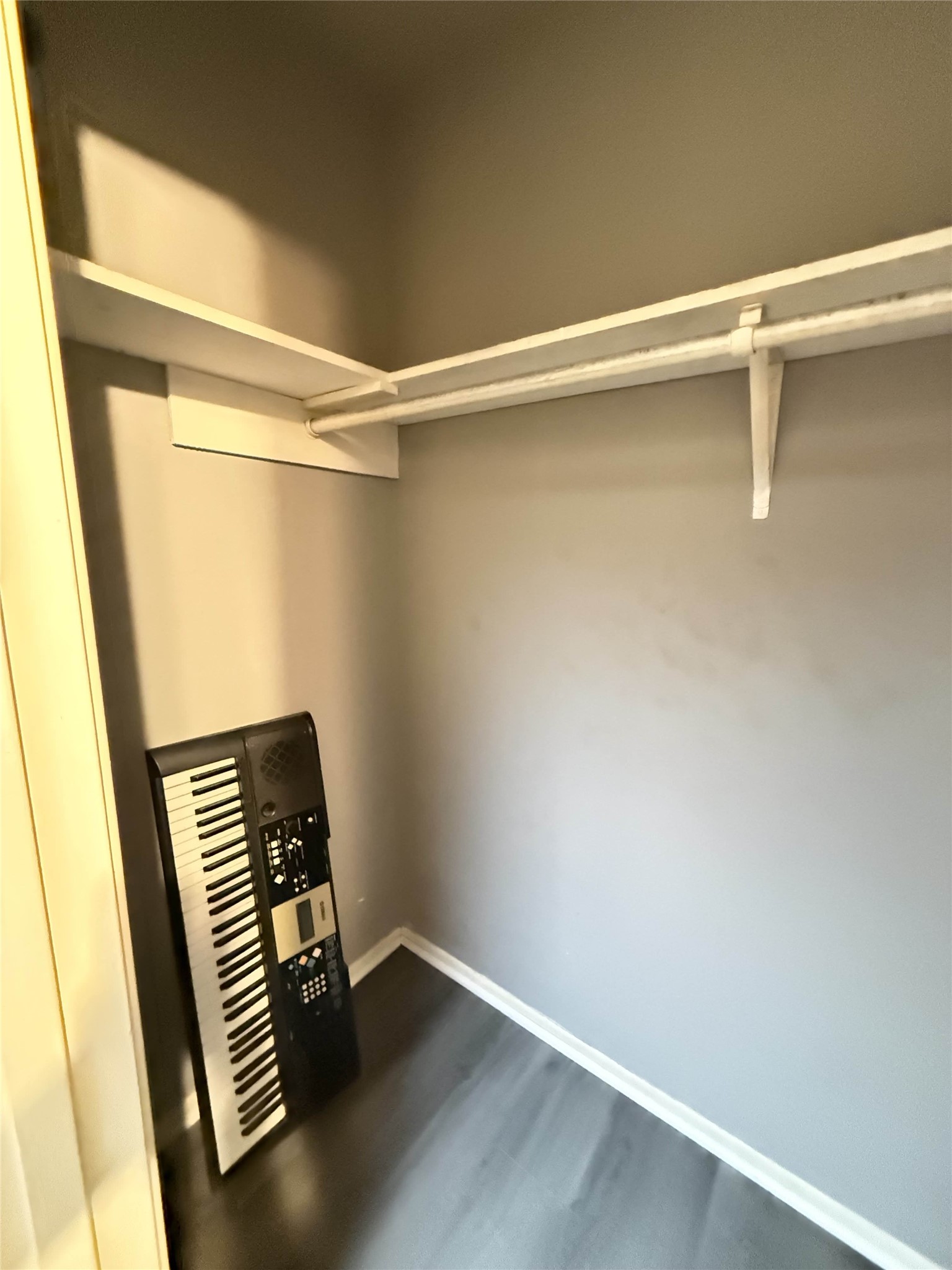 7047 Bissonnet Street, Unit 70 Houston, TX 77074 - Photo 18 of 23 a view of an empty room with wooden floor and stairs