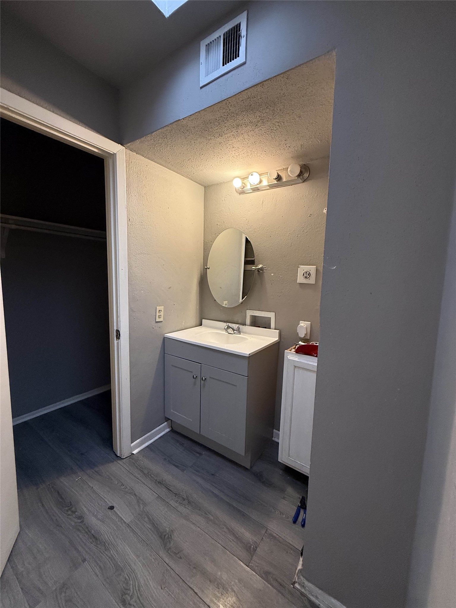 7047 Bissonnet Street, Unit 70 Houston, TX 77074 - Photo 19 of 23 a room with a mirror and a sink