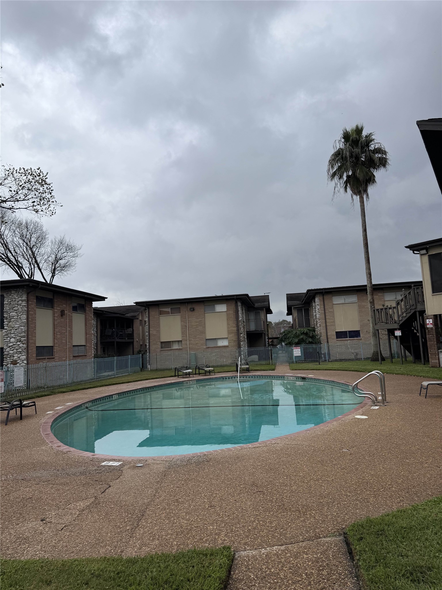 7047 Bissonnet Street, Unit 70 Houston, TX 77074 - Photo 2 of 23 a view of a house with swimming pool and a yard