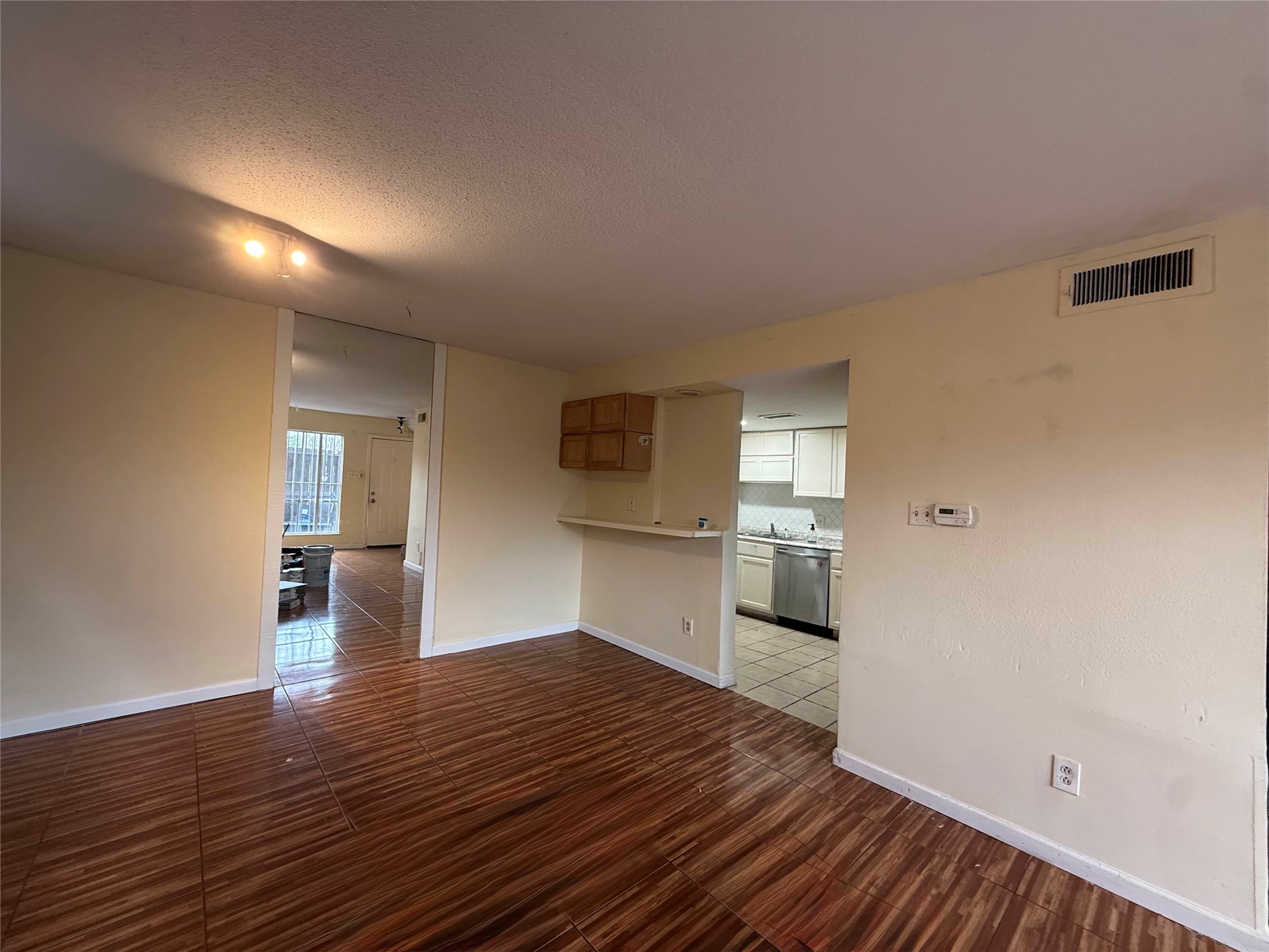 7047 Bissonnet Street, Unit 70 Houston, TX 77074 - Photo 10 of 23 a view of a kitchen with wooden floor and a kitchen