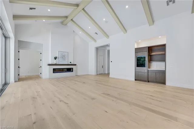 a view with cabinets a island and windows in it